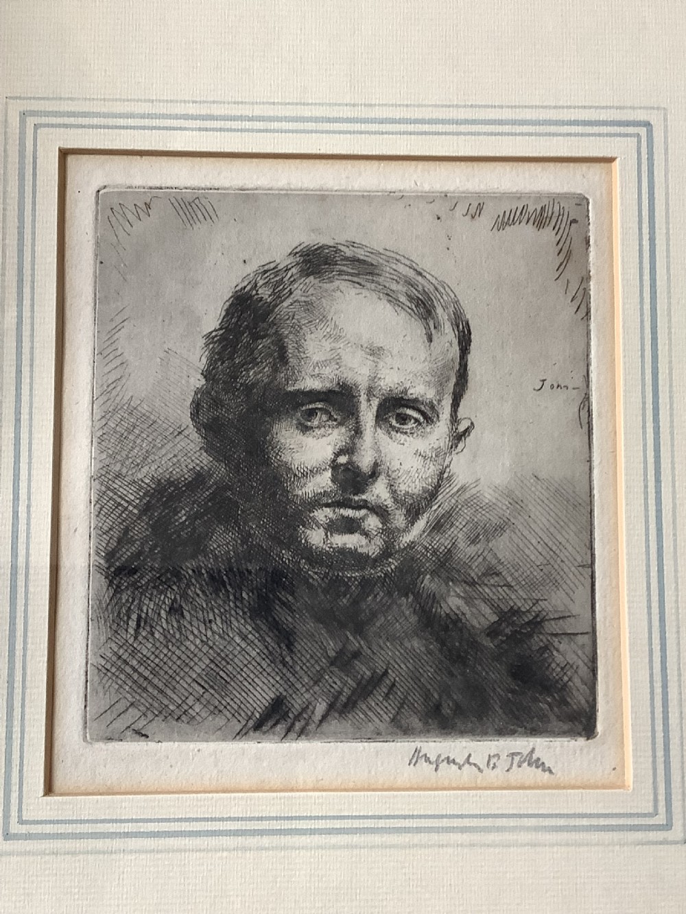 A framed monochrome portrait etching of a mans head executed with dense cross-hatching and signed in pencil beneath the plate mark.