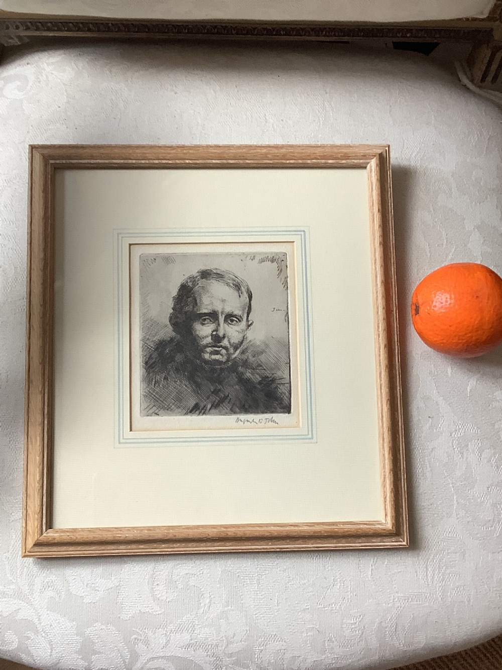 A framed monochrome portrait etching of a mans head executed with dense cross-hatching and signed in pencil beneath the plate mark. View II