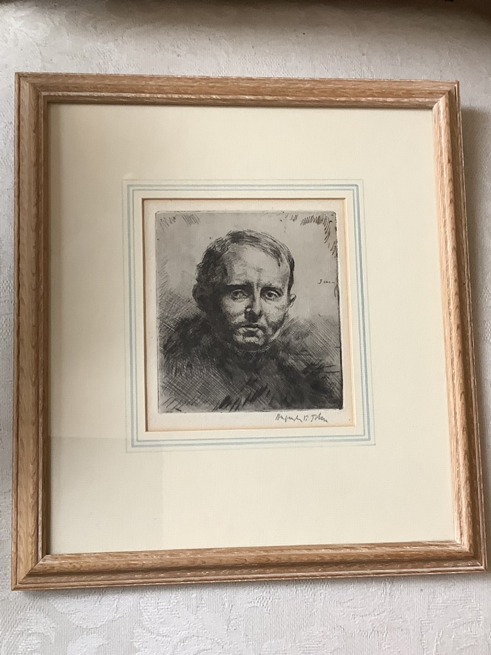 A framed monochrome portrait etching of a mans head executed with dense cross-hatching and signed in pencil beneath the plate mark. View III