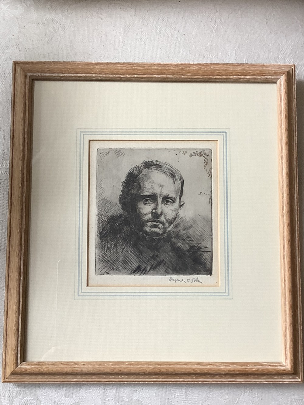 A framed monochrome portrait etching of a mans head executed with dense cross-hatching and signed in pencil beneath the plate mark. View V