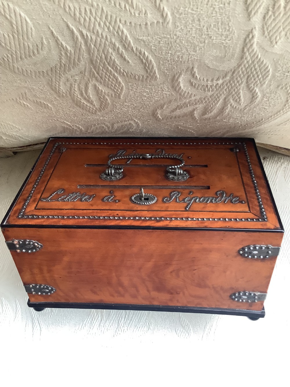 A French satinwood rectangular letter box featuring twin letter slots, cut steel studding forming French script lettering, a decorated steel handle, and corner mounts. View III