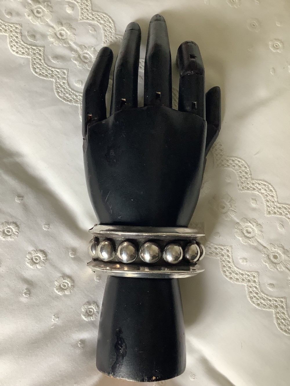 A wide sterling silver cuff bracelet featuring a central row of raised spherical studs bordered by raised outer rims. View III