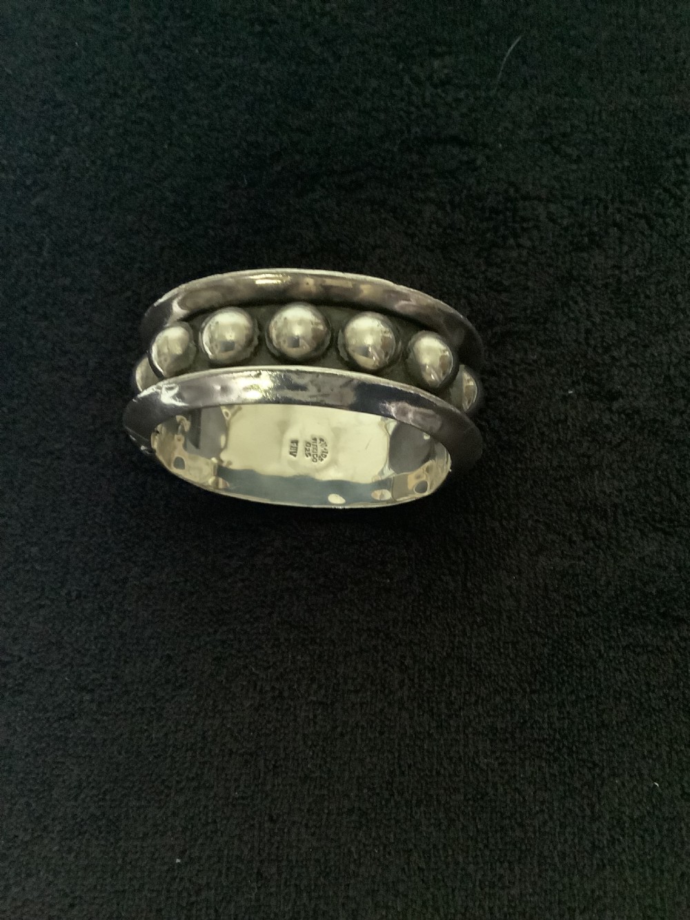 A wide sterling silver cuff bracelet featuring a central row of raised spherical studs bordered by raised outer rims. View V