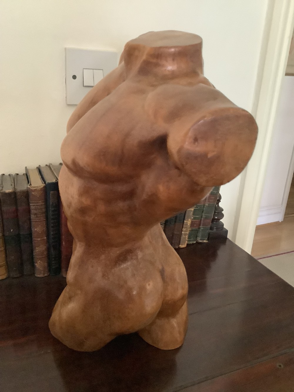 A three-dimensional carved hardwood sculpture depicting a classical male torso with defined muscle structure and a smooth polished finish. View VIII