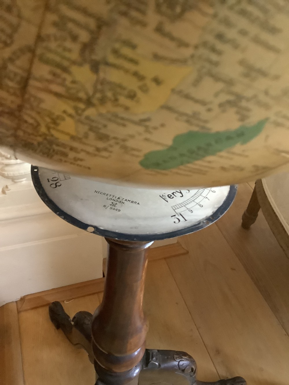 A terrestrial floor-standing globe mounted on a brass half-meridian, supported by a turned mahogany column with carved tripod cabriole legs. View II