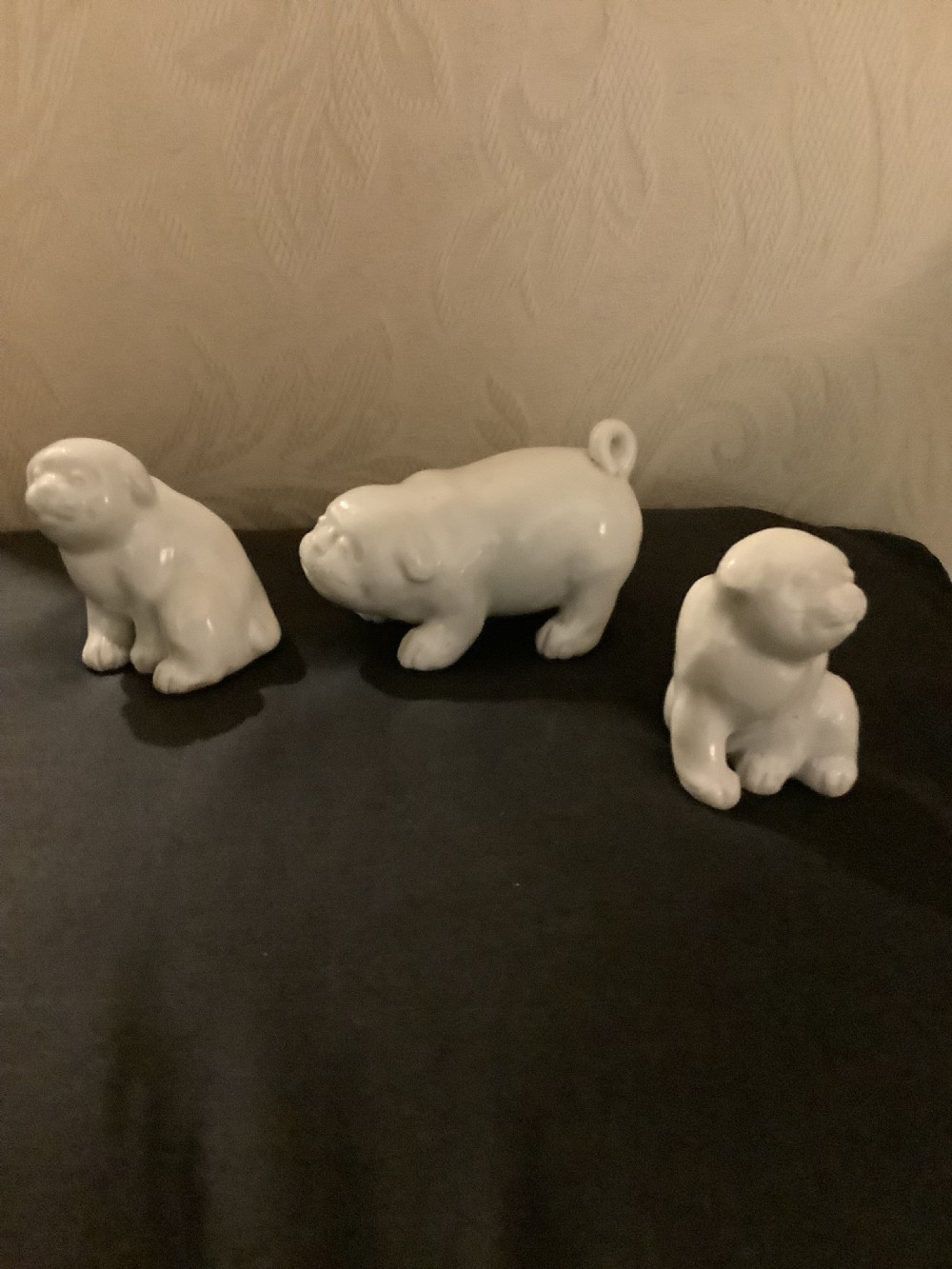 A set of three monochrome white glazed porcelain Japanese Hirado puppy figurines sculpted in seated and standing poses. View V