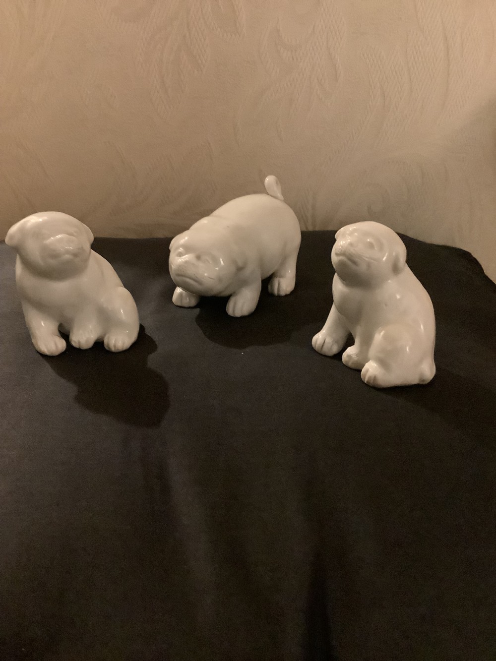 A set of three monochrome white glazed porcelain Japanese Hirado puppy figurines sculpted in seated and standing poses. View VII