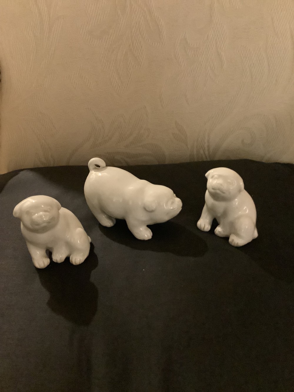 A set of three monochrome white glazed porcelain Japanese Hirado puppy figurines sculpted in seated and standing poses. View VIII