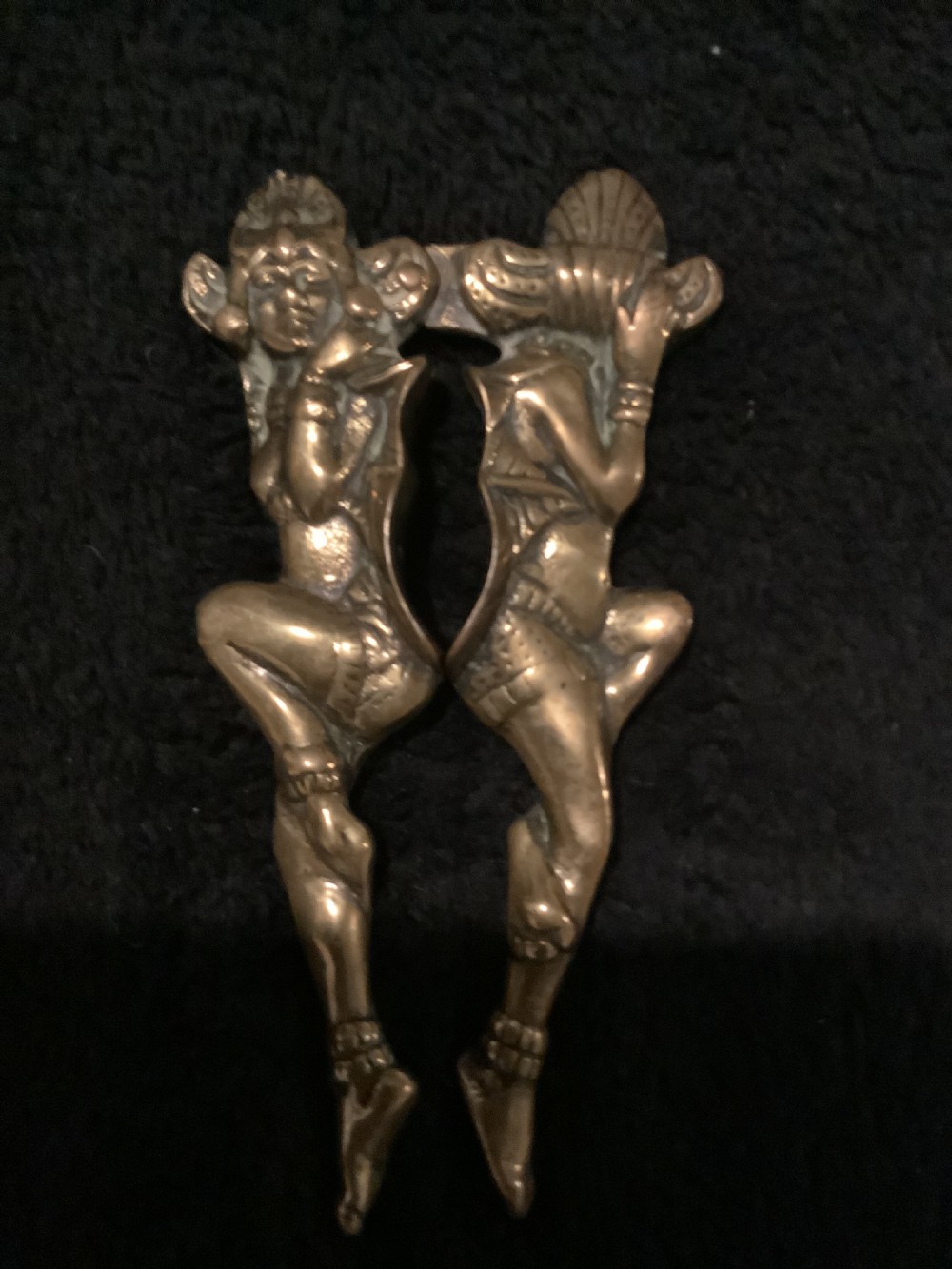 A cast brass novelty nutcracker fashioned in the form of two articulated dancing female figures.