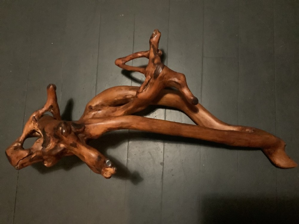 A polished yew wood sculpture featuring organic, intertwined smooth branches with a rich golden-amber tone. View II