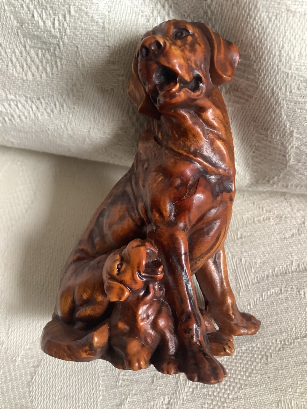A very finely carved small hardwood figure of dog and pup