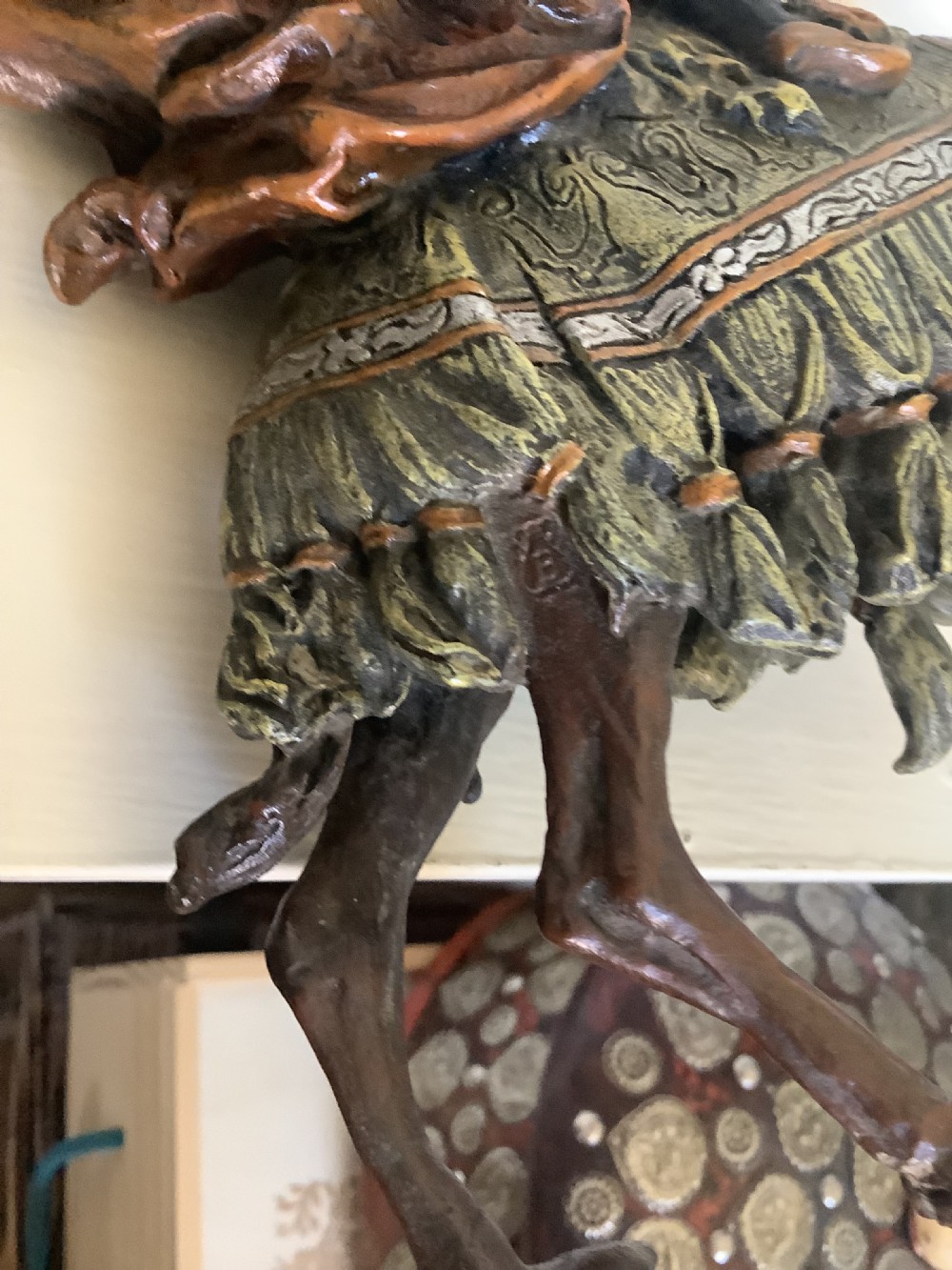 A cold painted bronze sculpture depicting a draped Arabic rider holding a rifle atop a camel. View VIII