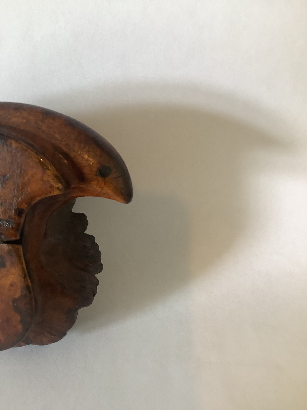 A hand-carved burr walnut snuff box crafted from an organic wood burl featuring natural texture and a polished surface. View VII