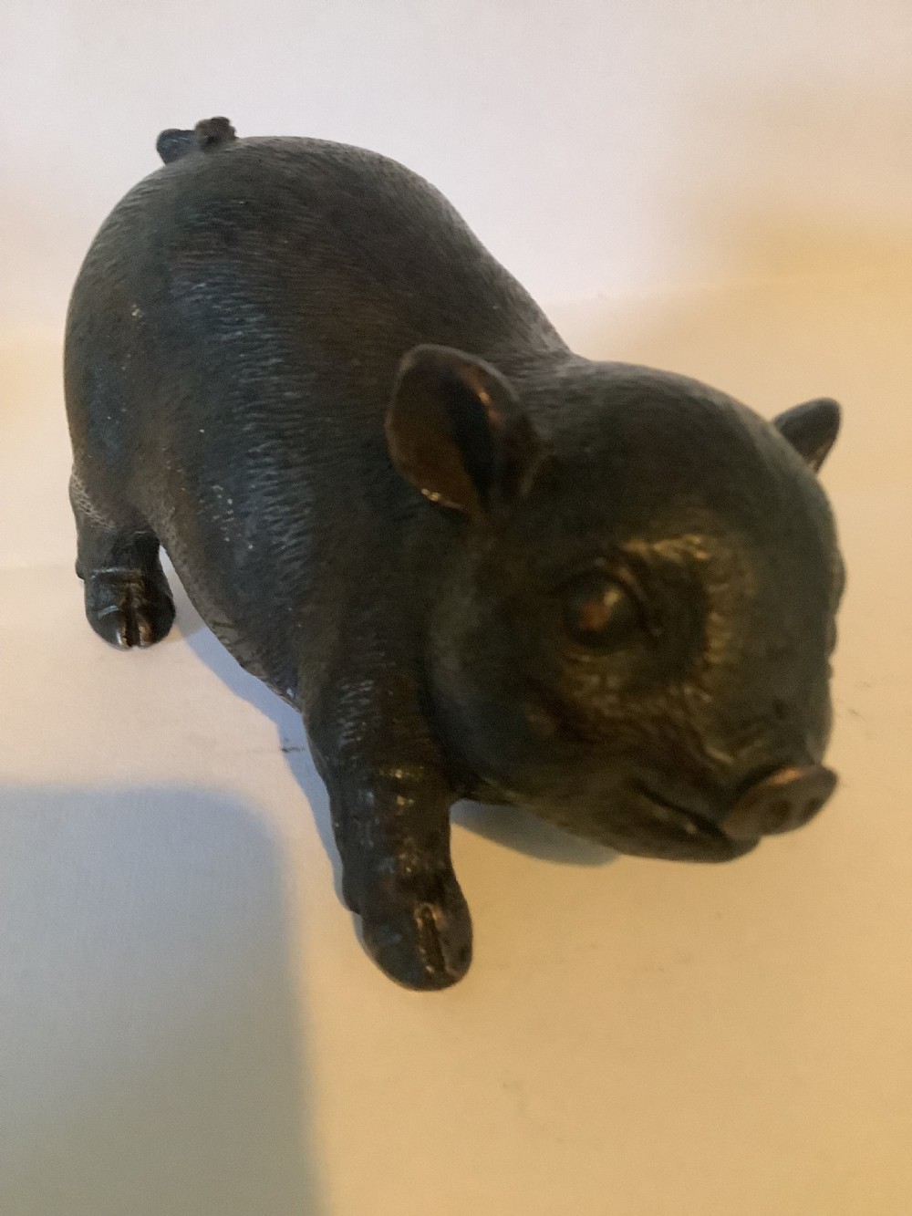 A 19th-century Chinese cast bronze figure of a pig with detailed incised hair texture and a dark brown patinated surface. View II