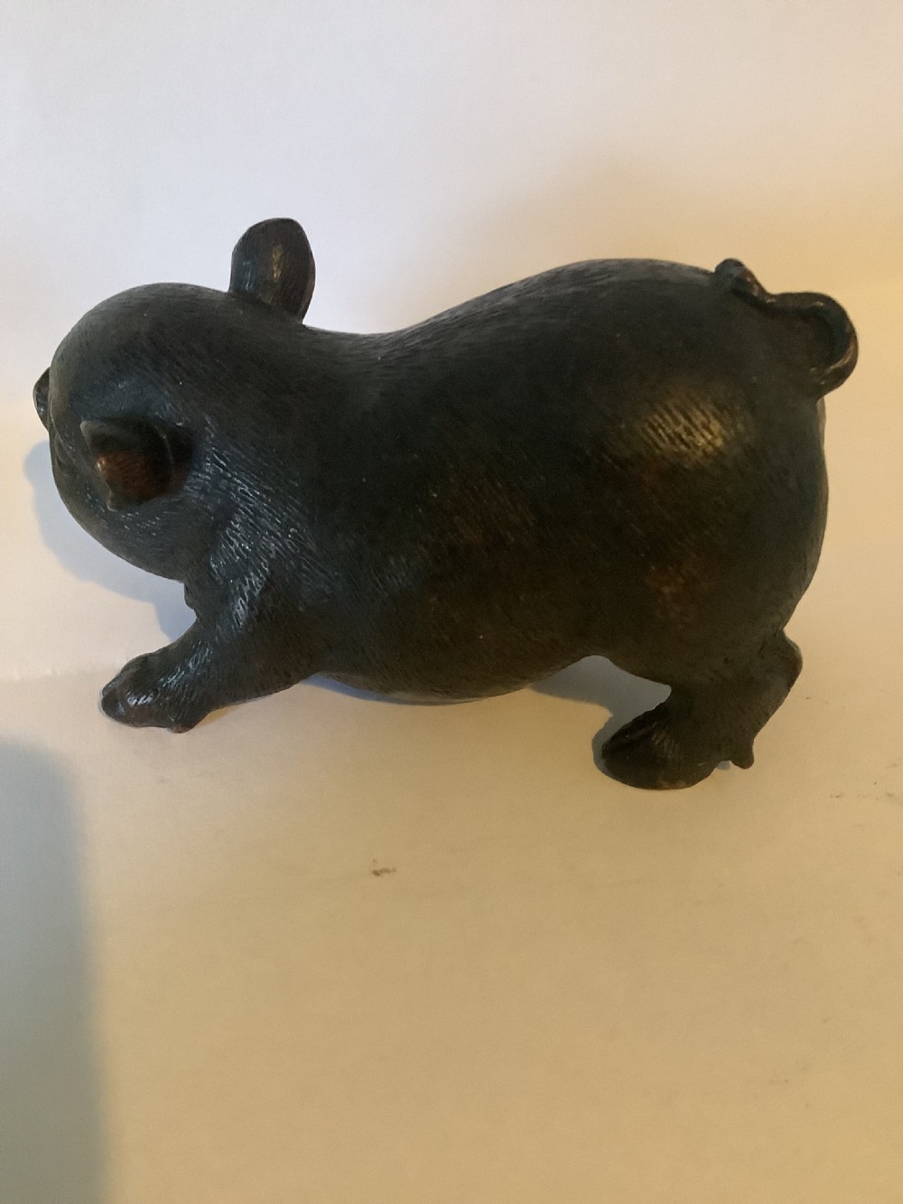 A 19th-century Chinese cast bronze figure of a pig with detailed incised hair texture and a dark brown patinated surface. View VI