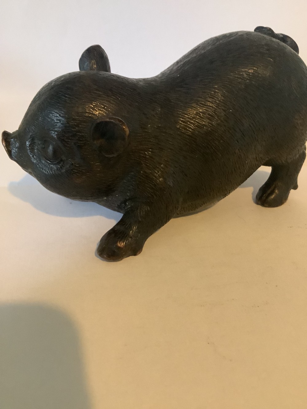A 19th-century Chinese cast bronze figure of a pig with detailed incised hair texture and a dark brown patinated surface. View VII