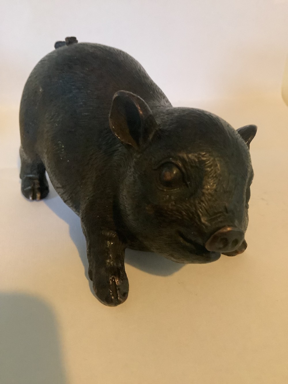 A 19th-century Chinese cast bronze figure of a pig with detailed incised hair texture and a dark brown patinated surface. View VIII