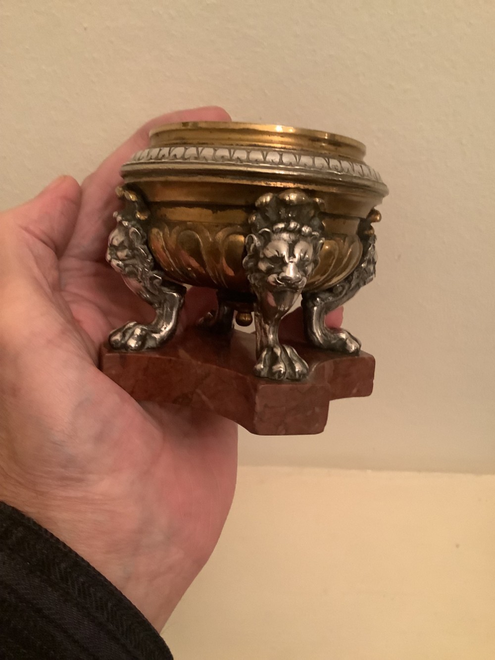 A pair of circular bronze and silvered metal tazzas featuring lion monopodia legs and resting on shaped red marble bases. View III