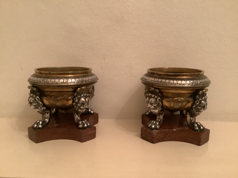 A pair of circular bronze and silvered metal tazzas featuring lion monopodia legs and resting on shaped red marble bases. View VI
