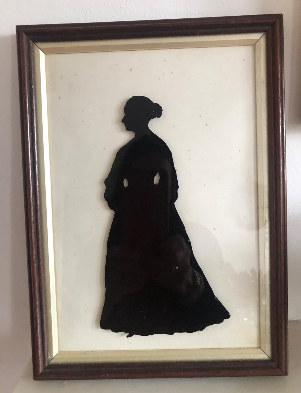 A large striking silhouette of a Victorian lady