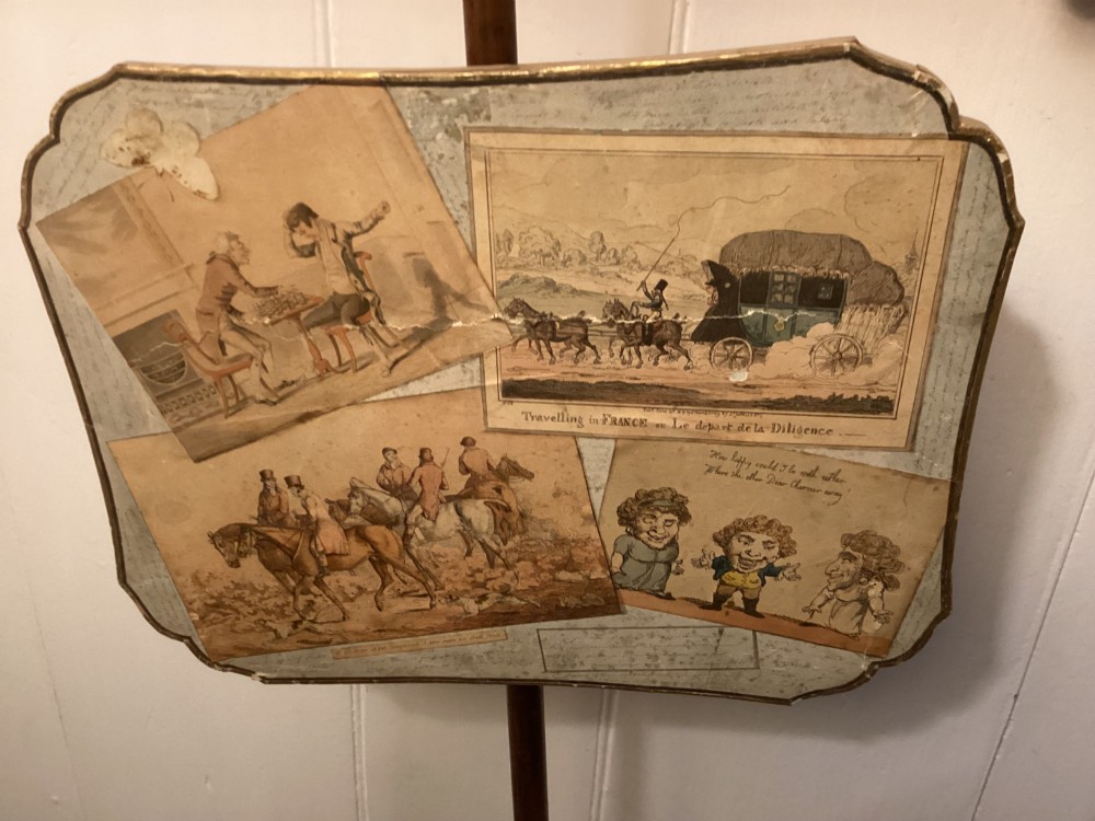 A pair of late George III mahogany pole screens featuring adjustable scalloped panels mounted with printed satirical caricatures on turned wooden stands with tripod bases. View III