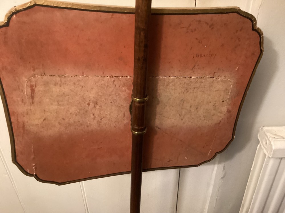 A pair of late George III mahogany pole screens featuring adjustable scalloped panels mounted with printed satirical caricatures on turned wooden stands with tripod bases. View IV