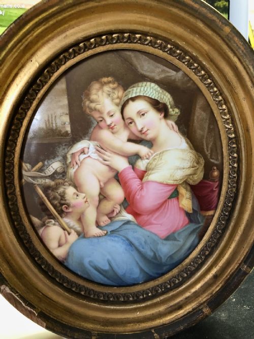 A CHARMING HAND PAINTED OVAL PORCELAIN PLAQUE OF THE MADONNA AND CHILD C1820