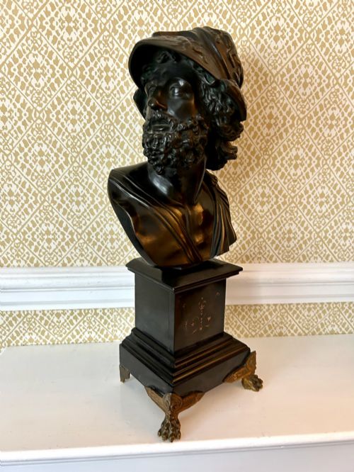 fig 1. A 19th-century dark bronze bust depicting the classical figure Ajax wearing a crested helmet, mounted on a black marble pedestal with gilt feet.