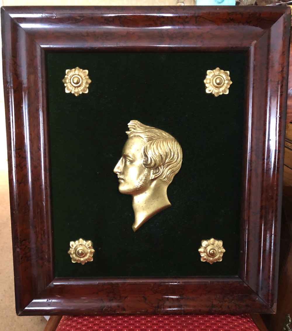 A framed Victorian gilt bronze profile relief portrait of Prince Albert mounted on dark green velvet inside a polished mahogany frame.