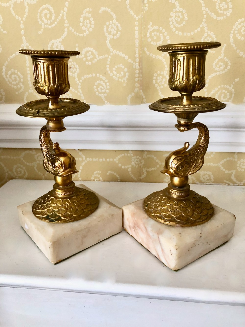 Pair of Early 19th century gilt bronze dolphin candlesticks