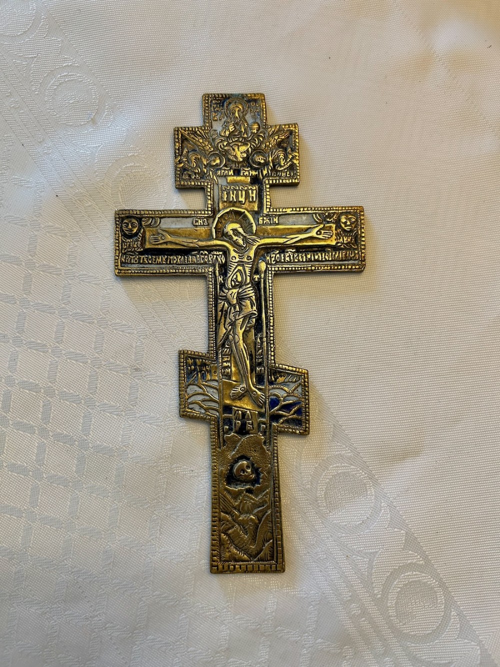 A 19th-century cast bronze Russian Orthodox eight-pointed cross featuring inlaid blue and white enamel detailing and Cyrillic inscriptions. View V