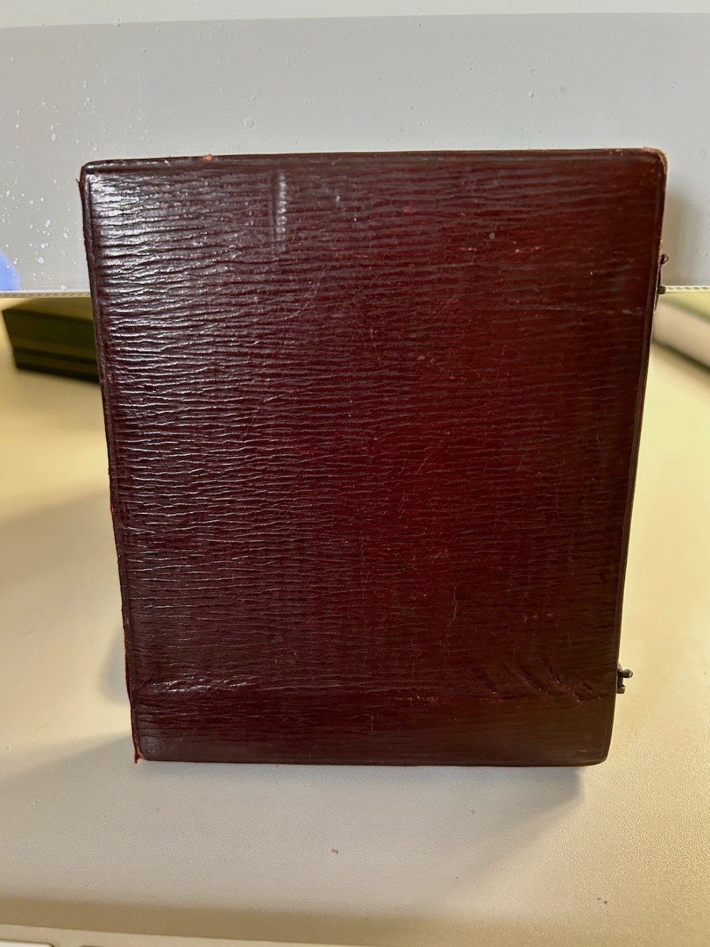 An early Victorian portrait miniature painting depicting a gentleman in a dark coat, housed within a red velvet-lined folding case. View IV