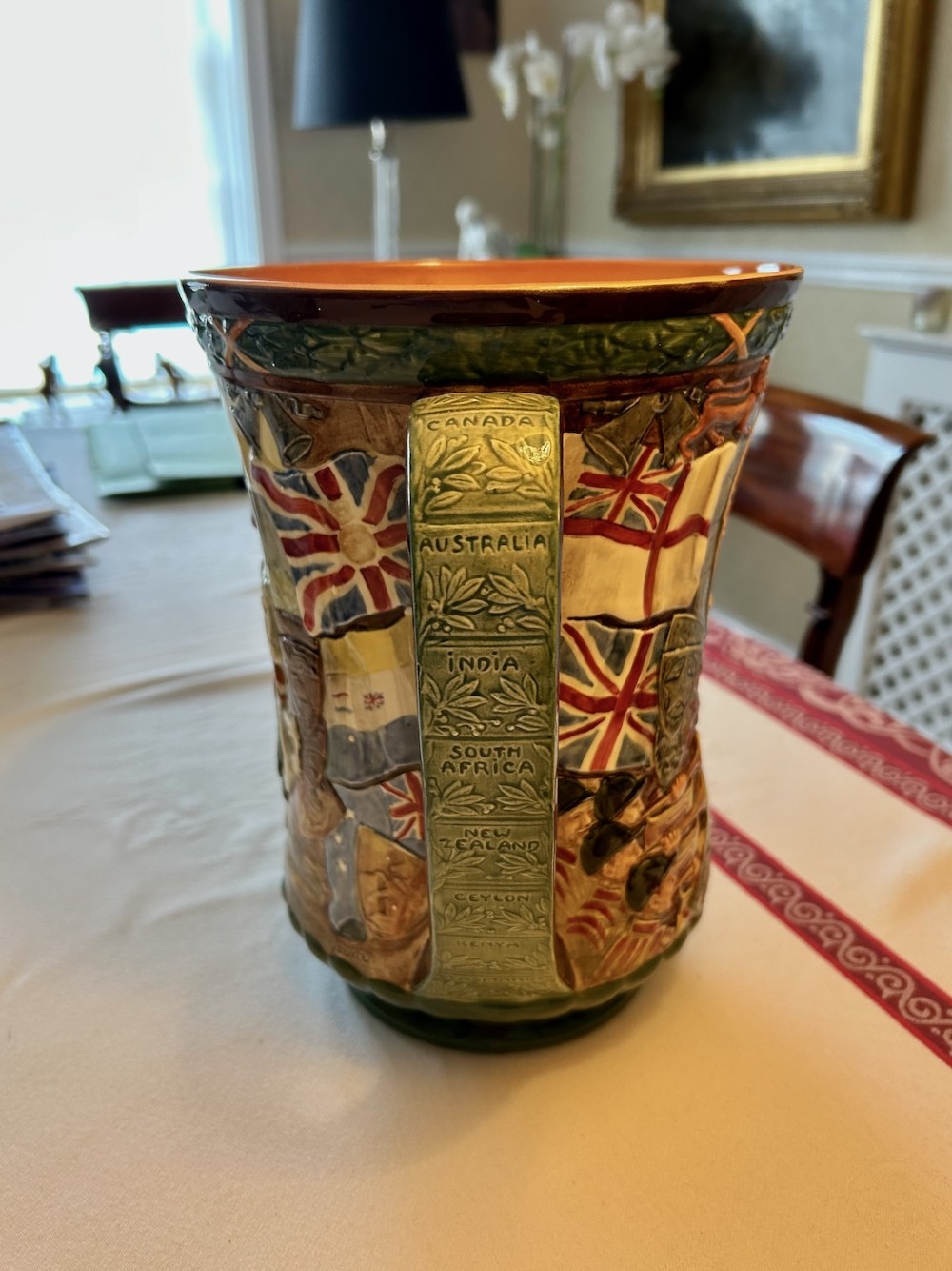 A brown glazed earthenware twin-handled loving cup featuring relief-moulded profile portraits of King George VI and Queen Elizabeth dated 1937. View II