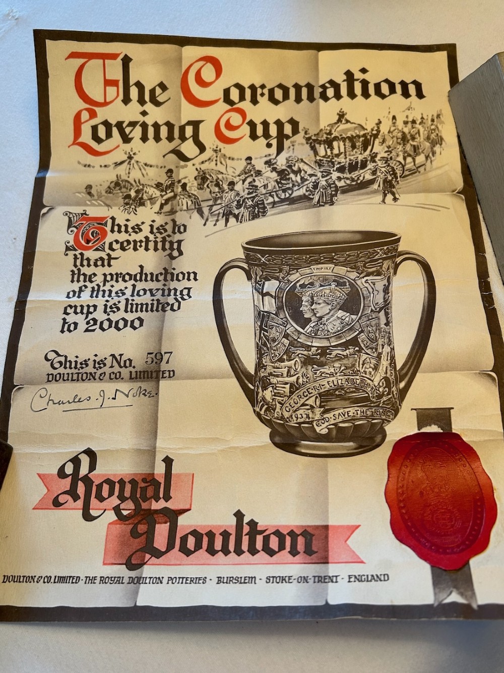 A brown glazed earthenware twin-handled loving cup featuring relief-moulded profile portraits of King George VI and Queen Elizabeth dated 1937. View III