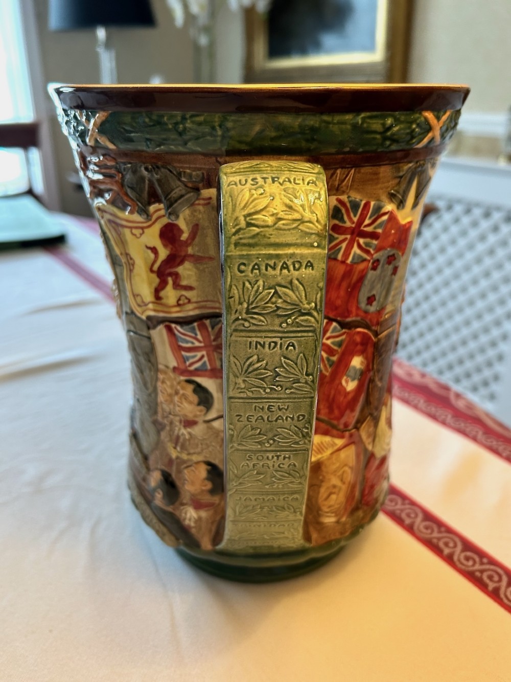 A brown glazed earthenware twin-handled loving cup featuring relief-moulded profile portraits of King George VI and Queen Elizabeth dated 1937. View IV