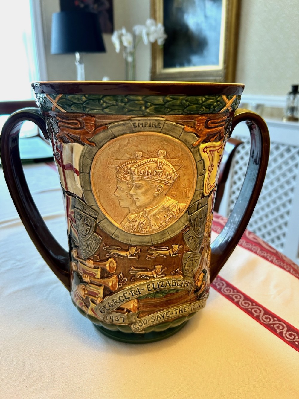 A brown glazed earthenware twin-handled loving cup featuring relief-moulded profile portraits of King George VI and Queen Elizabeth dated 1937. View V