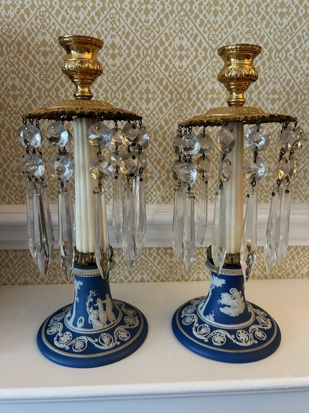 A pair of Victorian candle lustres featuring cobalt blue jasperware bases with white classical reliefs, topped with fluted column shafts, gilt sconces, and hanging cut glass crystal prisms. View III