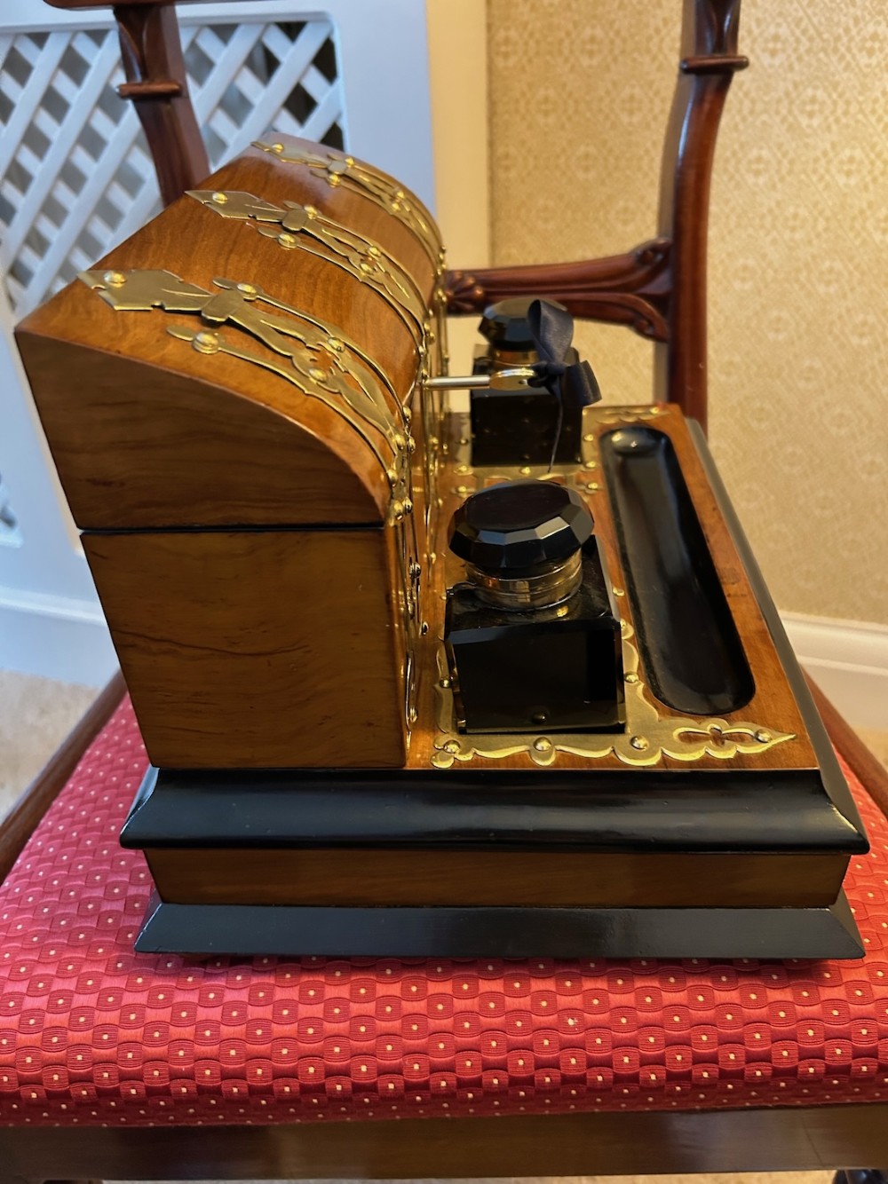 An open Victorian figured walnut desk stand featuring decorative brass strapwork, two black inkwells, a pen trough, and an upper stationery compartment lined in blue fabric. View III