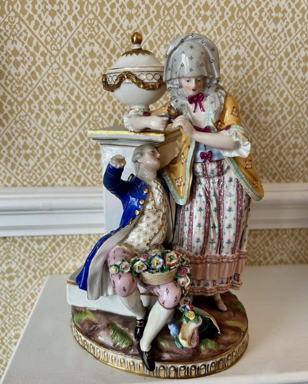 A pair of 19th-century hand-painted Meissen porcelain figurines depicting figures in 18th-century court dress alongside classical urns. View II