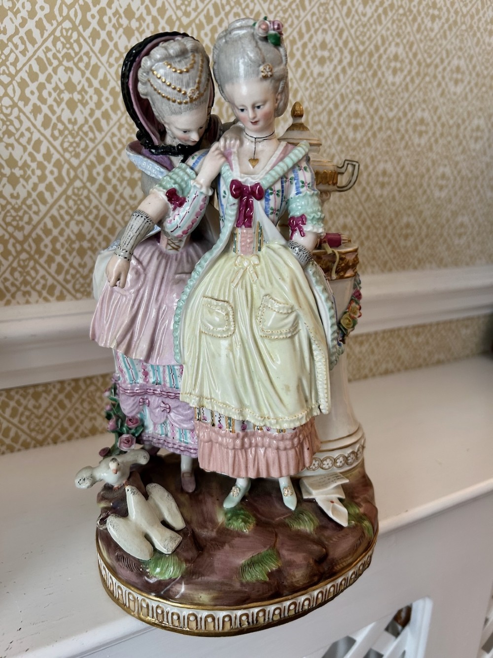 A pair of 19th-century hand-painted Meissen porcelain figurines depicting figures in 18th-century court dress alongside classical urns. View VII
