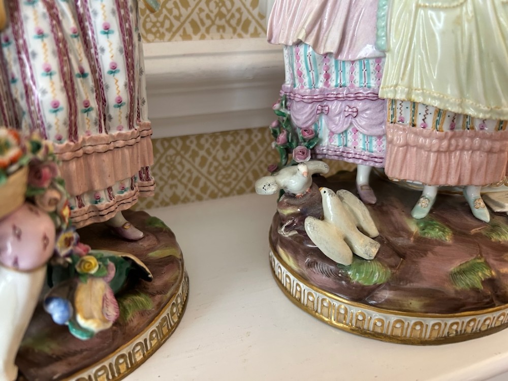 A pair of 19th-century hand-painted Meissen porcelain figurines depicting figures in 18th-century court dress alongside classical urns. View XI