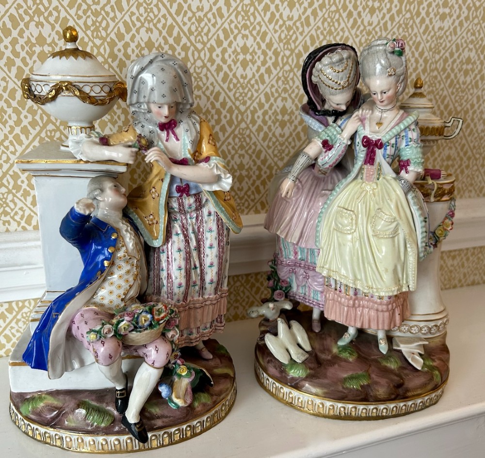 A pair of 19th-century hand-painted Meissen porcelain figurines depicting figures in 18th-century court dress alongside classical urns. View XIII