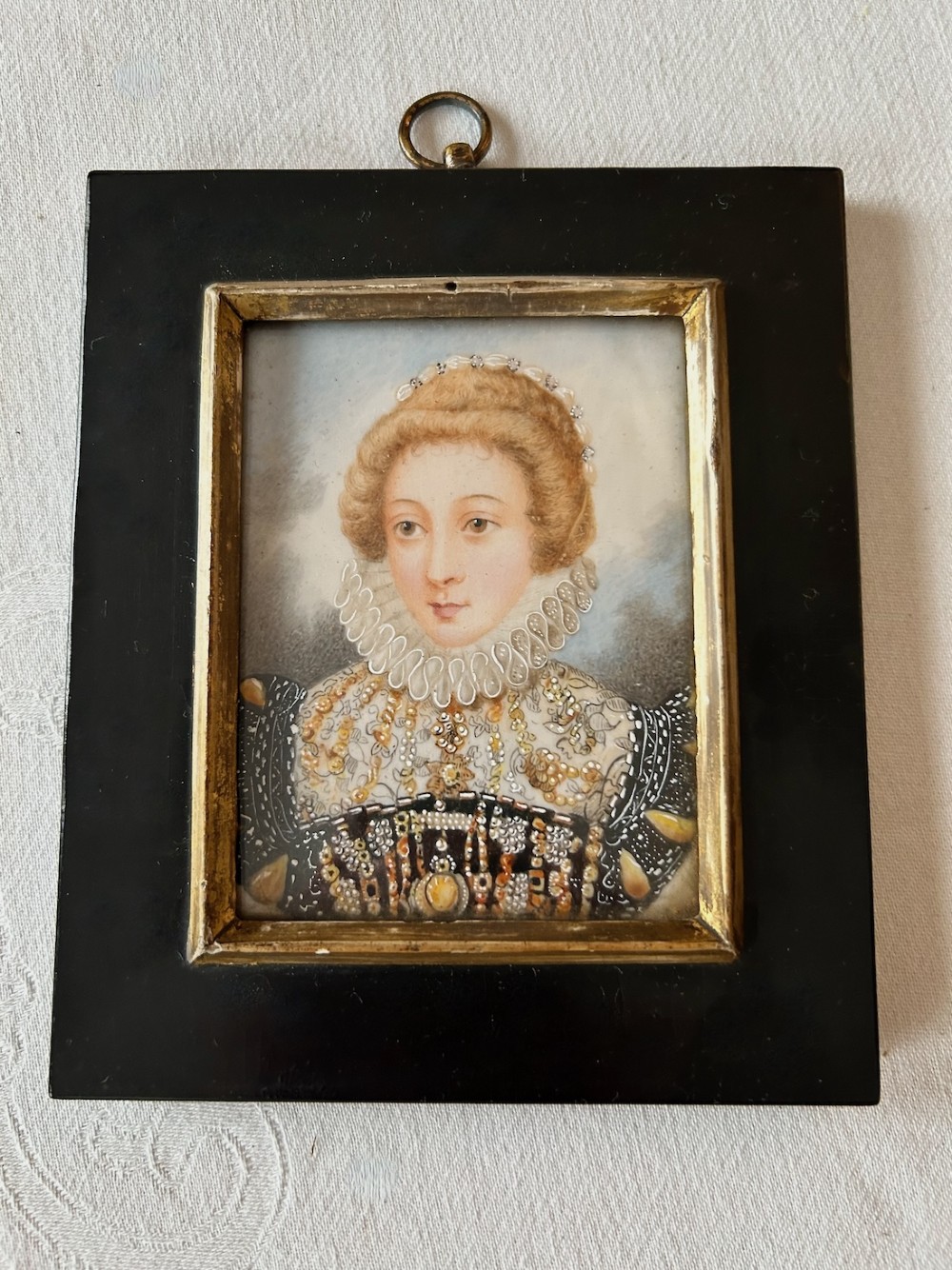 A rectangular ebonised framed portrait miniature depicting Mary, Queen of Scots wearing a lace ruff and embellished dress. View II