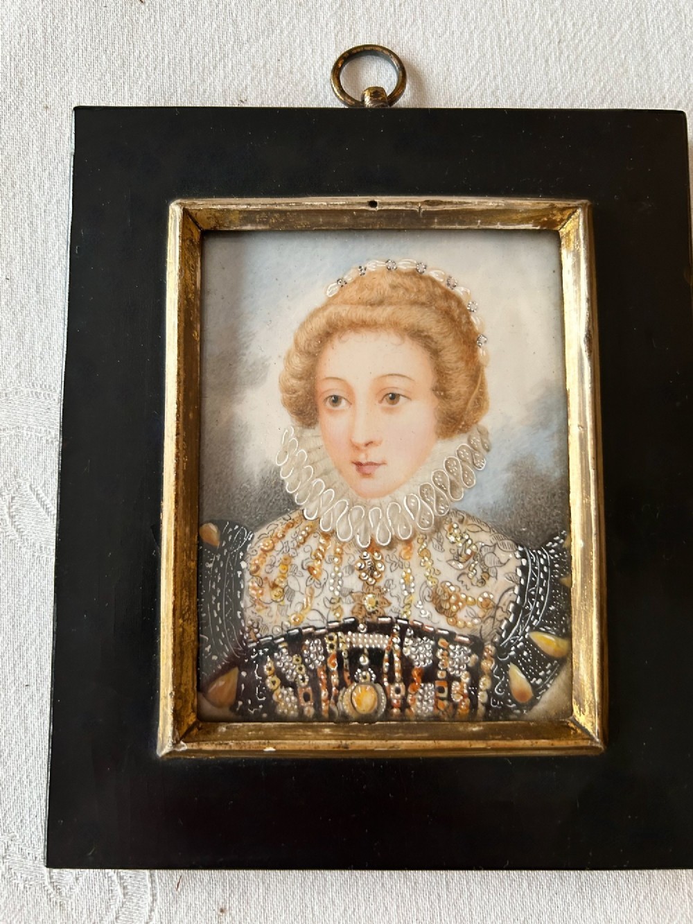 A rectangular ebonised framed portrait miniature depicting Mary, Queen of Scots wearing a lace ruff and embellished dress. View V