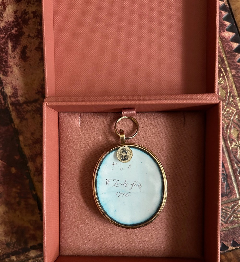 An oval Georgian portrait miniature set in a gold-tone metal frame depicting a gentleman with a long dark wig, white cravat, and blue coat. View III
