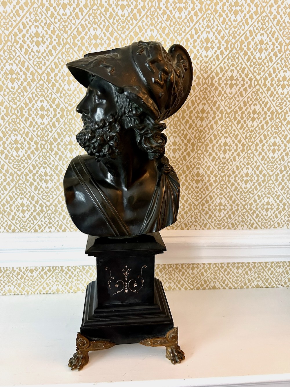 A 19th-century dark bronze bust depicting the classical figure Ajax wearing a crested helmet, mounted on a black marble pedestal with gilt feet. View VII