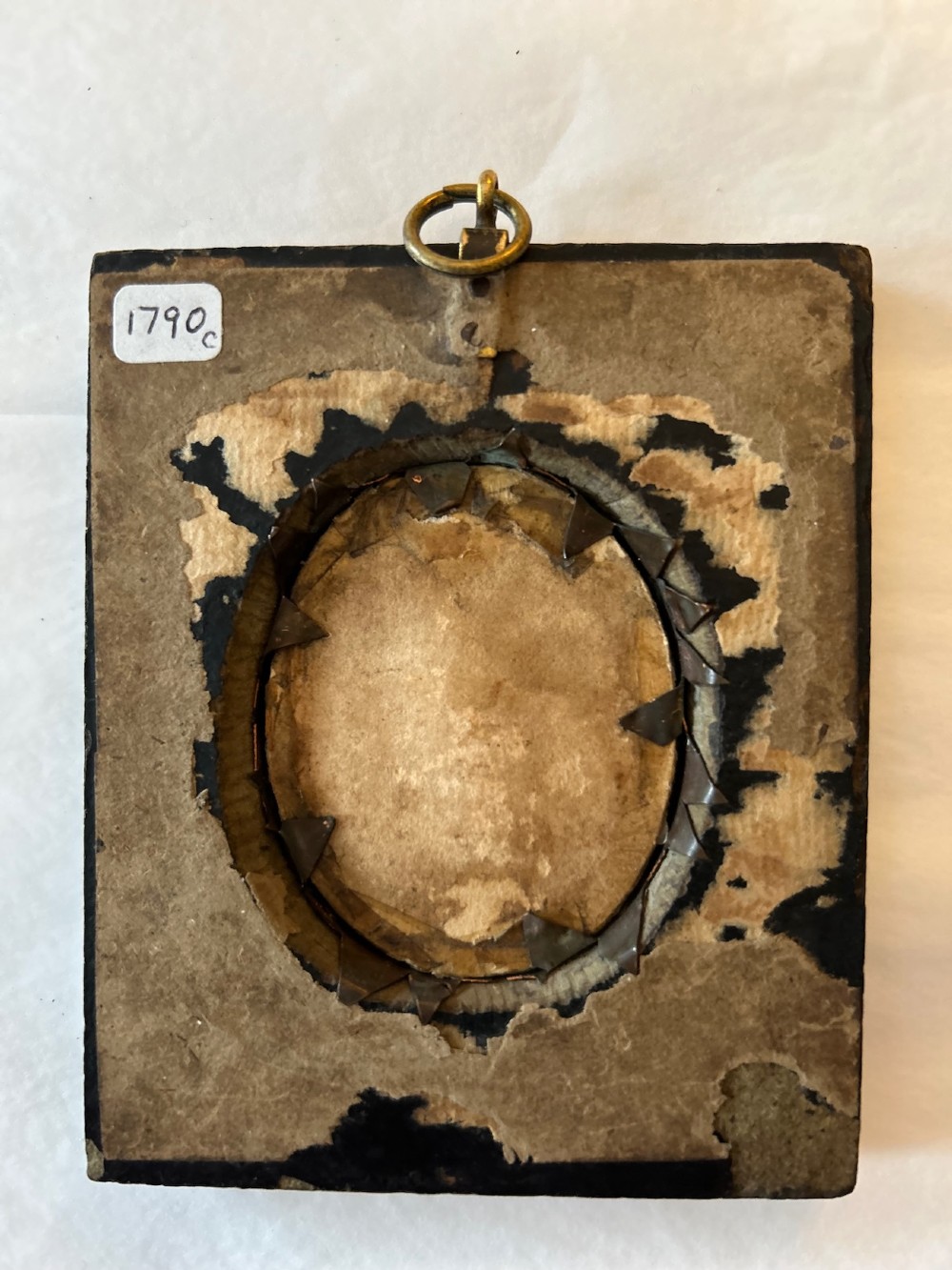 A late 18th-century oval portrait miniature depicting a lady in a red dress, mounted in an ebonised frame with a gilt brass bezel and acorn hanger. View III