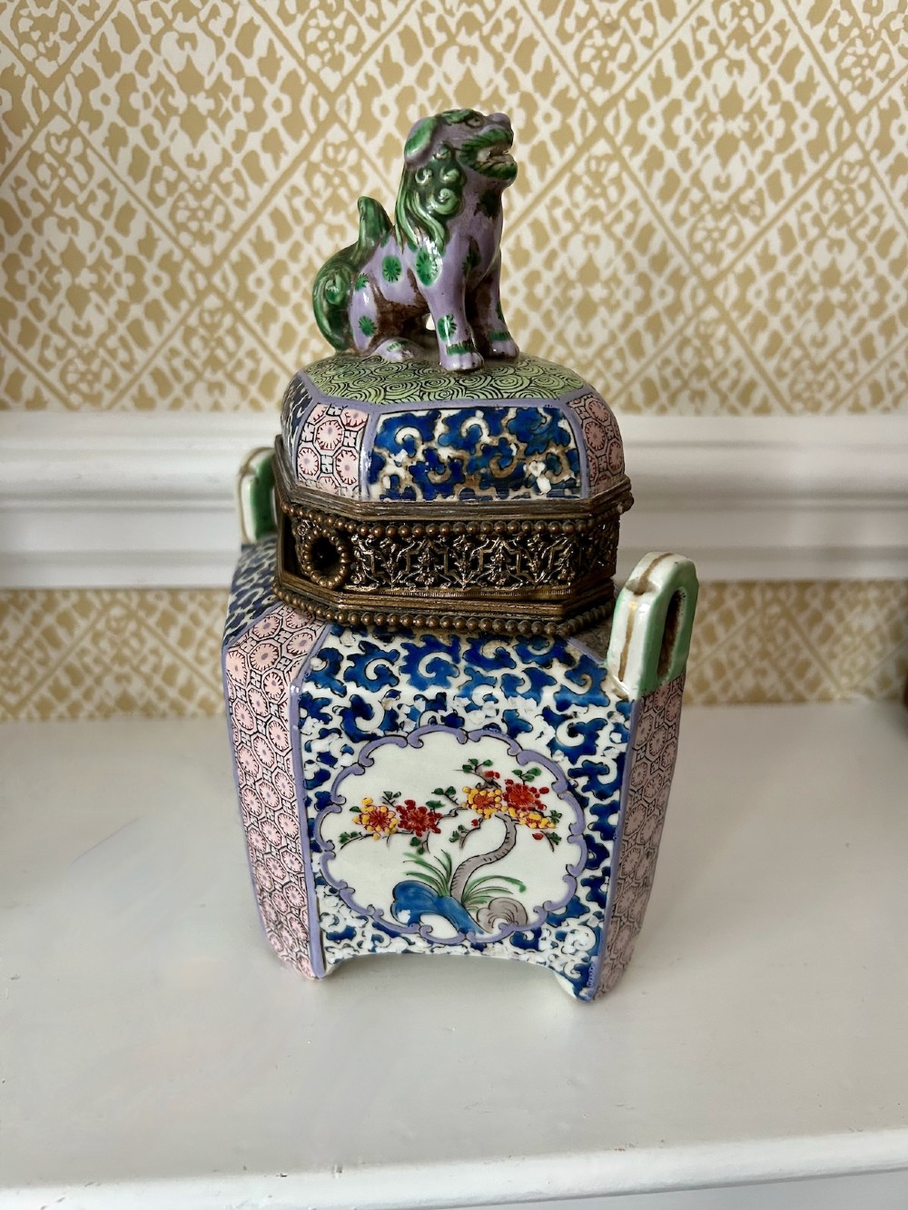 A square 19th-century Chinese porcelain censer featuring a purple foo lion finial on the lid, detailed polychrome enamel floral panels, and blue scrollwork borders. View III