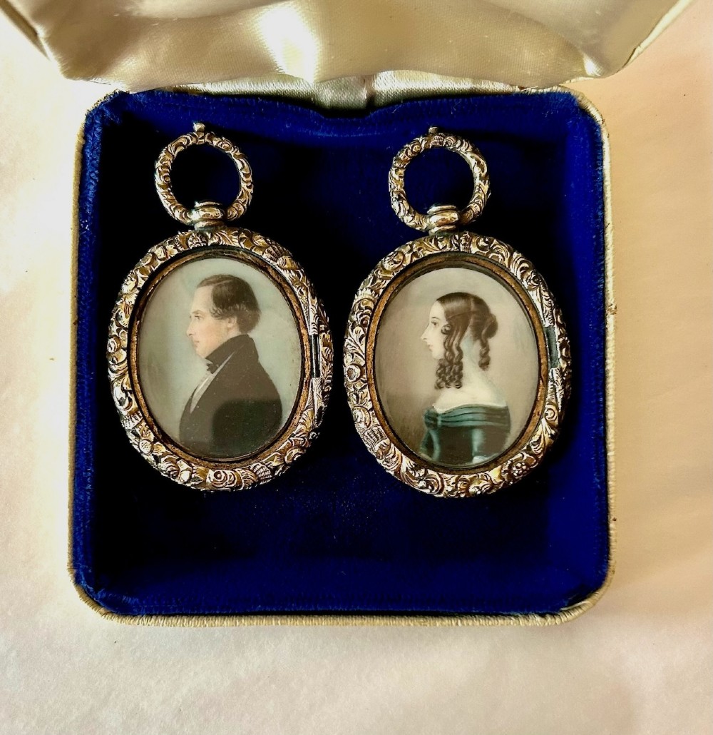 A Pair of Late 18th Century Portrait Miniatures of a Husband and Wife in Gilt Oval Frames