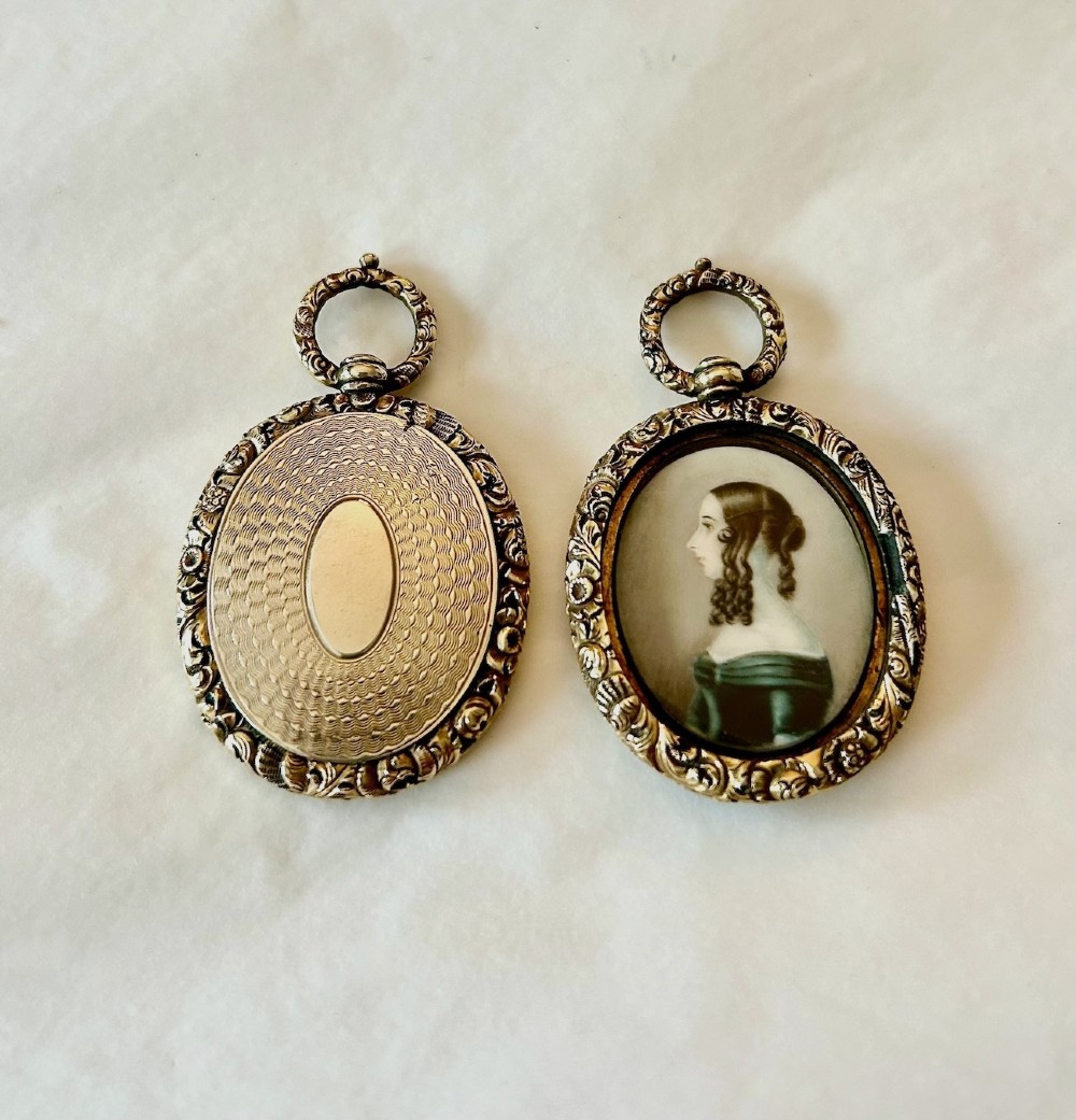 A Pair of Late 18th Century Portrait Miniatures of a Husband and Wife in Gilt Oval Frames View II
